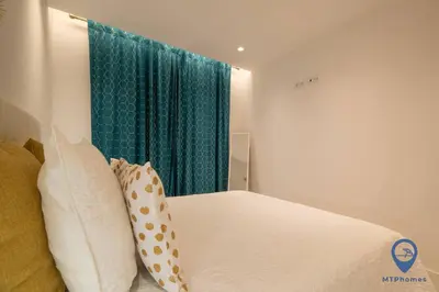 a bedroom with a bed and a green curtain at Vale Mangude B by MTPhomes in Albufeira