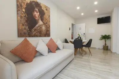 a living room with a couch and a painting on the wall at Solar Mendonca in Faro
