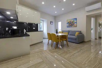 a kitchen and living room with a table and a couch at Solar Mendonca in Faro
