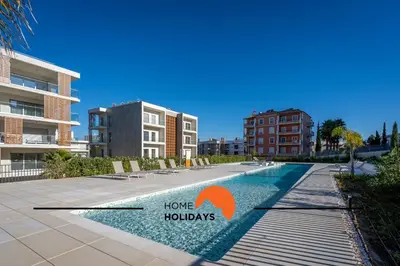 a swimming pool with a home holidays sign next to a building at #264 Green Apartments C04 by Home Holidays in Albufeira
