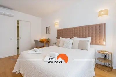 a bedroom with a large bed with a home holidays sign on it at #264 Green Apartments C04 by Home Holidays in Albufeira