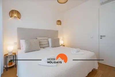 a bedroom with a bed with a home hollidays sign on it at #264 Green Apartments C04 by Home Holidays in Albufeira