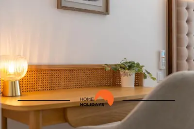 a wooden table with a lamp and a chair at #264 Green Apartments C04 by Home Holidays in Albufeira
