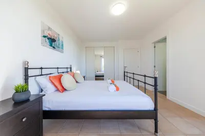 a bedroom with a bed with orange and white pillows at Townhouse Ocean Joy by Algarve Vacation in Albufeira