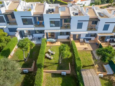 an aerial view of a villa with palm trees at Townhouse Ocean Joy by Algarve Vacation in Albufeira