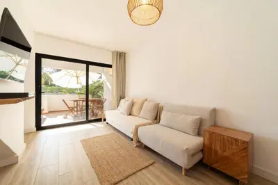 a living room with a couch and a table at Falésia Sunset Villa by HelloVacations in Albufeira