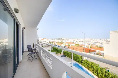 a balcony with a view of a city at Ocean Apt 200meters Beach AC Wi-Fi Balcony in Albufeira