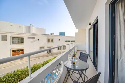 a balcony with a table and a laptop on it at Ocean Apt 200meters Beach AC Wi-Fi Balcony in Albufeira