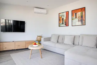 a living room with a couch and a table at Ocean Apt 200meters Beach AC Wi-Fi Balcony in Albufeira