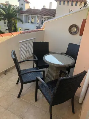 a patio with chairs and a table on a balcony at Old Village Vilamoura Beautiful 3 Bed townhouse in Vilamoura