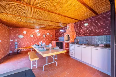 a kitchen with a wooden table in a room at Villa Laranja in Guia