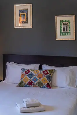 a white bed with pillows and a towel on it at Villa Laranja in Guia
