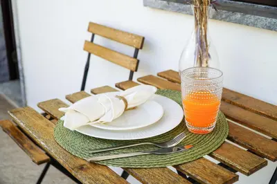 a table with plates and a glass of orange juice at Apartment Marisela in Albufeira