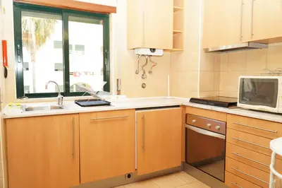 a kitchen with a sink and a microwave at Sacada Apartment in Guia
