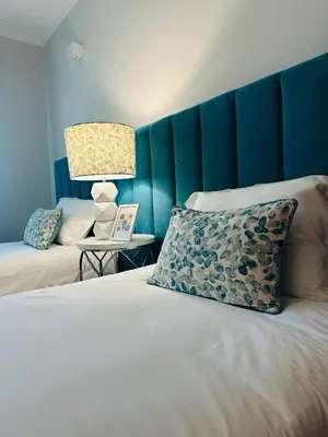 a bedroom with a blue headboard and a bed with a pillow at Appartement Talia in Albufeira