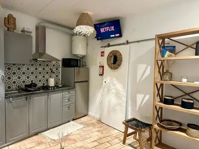 a kitchen with grey cabinets and a sign on the wall at Casa Da Alegria in Albufeira