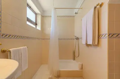 a bathroom with a tub and a sink at Casa Rita by Sunnyway in Olhos de Água