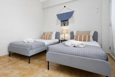 two beds sitting next to each other in a room at ISA - Quarteira in Quarteira