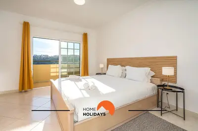 a bedroom with a large bed and a large window at #257 Villa Sun & Sea by Home Holidays in Albufeira