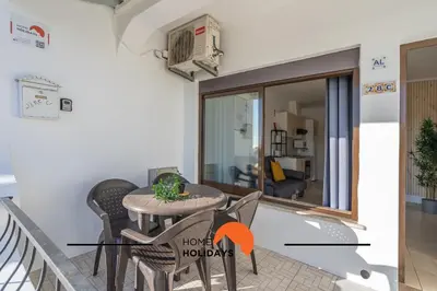 a living room with a table and chairs at #253 Fernando Pessoa 28 by Home Holidays in Albufeira