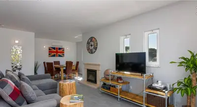 a living room with a couch and a flat screen tv at Ville Verde in Loulé