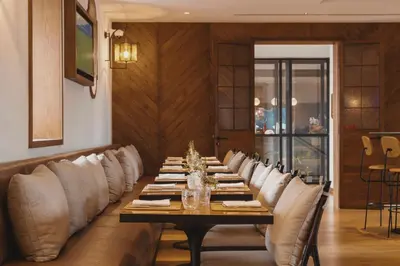 a long dining room with a long table and chairs at Viceroy Residences at Ombria Algarve in Loulé