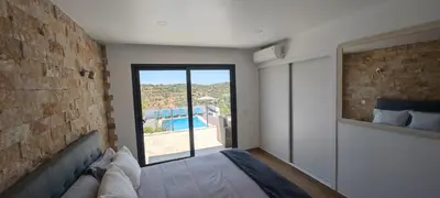 a living room with a fireplace and a table and chairs at The View House in Albufeira