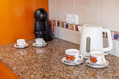 a counter with cups and saucers on top of it at Villa Bellegarde by Algarve Vacation in Albufeira