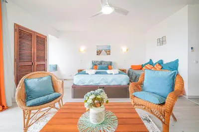 a bedroom with a bed and two chairs and a table at SeaView apartment by MOJE Holiday in Albufeira