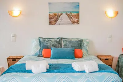a bedroom with a blue bed with towels on it at SeaView apartment by MOJE Holiday in Albufeira