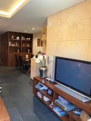 a living room with a large flat screen tv at Barca do Lago - Vilamoura in Vilamoura