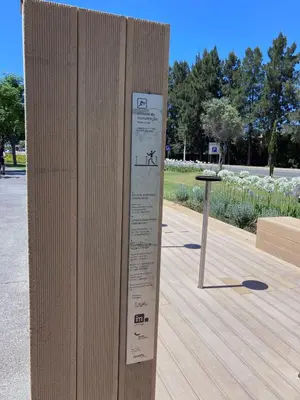 a wooden wall with a sign on it in a park at Barca do Lago - Vilamoura in Vilamoura