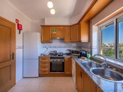 a living room with a couch and a tv and a table at Apartment Valmangude Sunny Escape - VIP Properties by Interhome in Albufeira