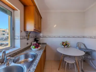 a kitchen with a sink and a washing machine at Apartment Valmangude Sunny Escape - VIP Properties by Interhome in Albufeira