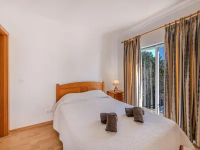 a dining room with a wooden table and chairs at Holiday Home V3 Aguia M - VIP Properties by Interhome in Albufeira