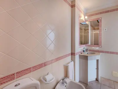 a bathroom with a sink and a mirror at Holiday Home V3 Aguia M - VIP Properties by Interhome in Albufeira