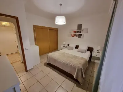 a bedroom with a large bed in a room at Appartement Algarve,Quarteira Vilamoura Lago Azul in Vilamoura