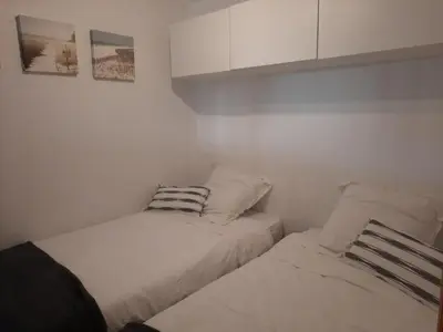 two beds in a small room with white walls at Appartement Algarve,Quarteira Vilamoura Lago Azul in Vilamoura