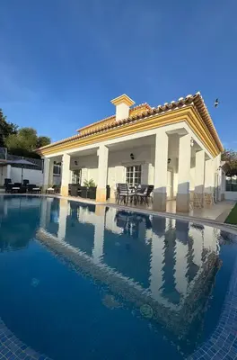 a large swimming pool in front of a house at Villa Bonita Guesthouse Albufeira Old Town in Albufeira