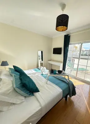 a bedroom with a large bed and a television at Villa Bonita Guesthouse Albufeira Old Town in Albufeira