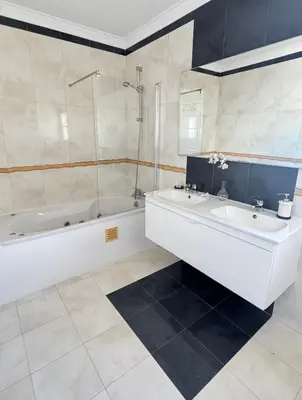 a bathroom with a tub and a sink and a bath tub at Villa Bonita Guesthouse Albufeira Old Town in Albufeira