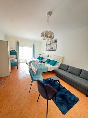 a living room with a couch and a table and chairs at Villa Bonita Guesthouse Albufeira Old Town in Albufeira