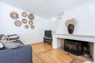 a living room with a couch and a fireplace at Villa Bonita in Albufeira