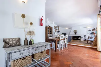 a living room and dining room with a table and chairs at Villa Bonita in Albufeira