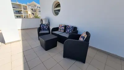 a living room with two chairs and a couch at Sea View Penthouse in Albufeira in Albufeira