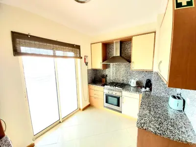 a kitchen with a sink and a stove top oven at Sea View Penthouse in Albufeira in Albufeira