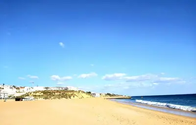 a view of a beach with the ocean and buildings at Sea View Penthouse in Albufeira in Albufeira