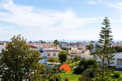 a blue towel with a picture of a house on it at #191 Smile Apartment by Home Holidays in Albufeira