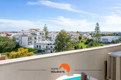 a swimming pool in a hotel with buildings in the background at #191 Smile Apartment by Home Holidays in Albufeira