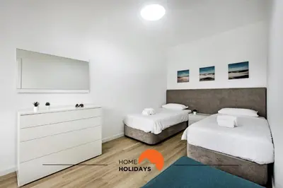a bedroom with two beds and a dresser in it at #211 Cerro Lagoa by Home Holidays in Albufeira
